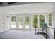 Bright living room featuring large windows, glass doors to the deck, and a unique spiral staircase adds character at 6381 Lakeview Dr, Buford, GA 30518