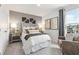Comfortable bedroom with stylish decor, carpet floors, and a large window at 8501 Polston Place Lot 143 Pl, Douglasville, GA 30134