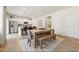 Open-concept dining area featuring a dining table with bench seating, next to the kitchen at 8501 Polston Place Lot 143 Pl, Douglasville, GA 30134