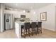 Modern kitchen with stainless steel appliances, a center island with bar stools, and pendant lighting at 8501 Polston Place Lot 143 Pl, Douglasville, GA 30134