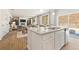 Gourmet kitchen with island and sink, and an adjacent dining area with hardwood floors at 8501 Polston Place Lot 143 Pl, Douglasville, GA 30134