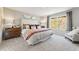 Beautiful main bedroom with neutral tones, a large window, and a cozy seating area at 8501 Polston Place Lot 143 Pl, Douglasville, GA 30134