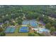 Aerial view of community tennis courts, pool, and lush greenery, showcasing recreational amenities at 2330 Wood Creek Ct, Dacula, GA 30019