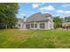 Expansive backyard with lush green lawn, patio, and white siding on a charming two-story home at 2330 Wood Creek Ct, Dacula, GA 30019