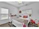 Charming bedroom with white furniture and ample natural light at 2330 Wood Creek Ct, Dacula, GA 30019