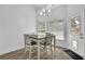 Cozy dining area with white table and chairs, illuminated by natural light at 2330 Wood Creek Ct, Dacula, GA 30019