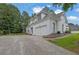 Pristine white brick exterior with a two-car garage and well-maintained landscaping enhances curb appeal at 2330 Wood Creek Ct, Dacula, GA 30019