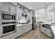 Modern kitchen with stainless steel appliances, white countertops, and gray cabinets at 2330 Wood Creek Ct, Dacula, GA 30019