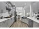 Modern kitchen with stainless steel appliances, white countertops, and gray cabinets at 2330 Wood Creek Ct, Dacula, GA 30019