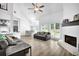 Open-concept living room with vaulted ceilings and brick fireplace at 2330 Wood Creek Ct, Dacula, GA 30019