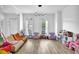 Bright living room featuring hardwood floors, large windows, and stylish decor at 2330 Wood Creek Ct, Dacula, GA 30019