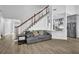 Spacious living room with staircase and view of modern kitchen at 2330 Wood Creek Ct, Dacula, GA 30019
