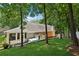 Brick home exterior with hot tub and screened patio overlooking grassy lawn at 3978 Devonshire Dr, Marietta, GA 30066