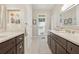 Bathroom with double vanity, stone countertops, dark cabinets, and decorative accents at 3978 Devonshire Dr, Marietta, GA 30066