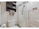 Modern bathroom featuring a glass-enclosed shower with tiled walls and built-in shelving at 3978 Devonshire Dr, Marietta, GA 30066