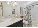 Well-lit bathroom featuring a black vanity, neutral walls, and shower with a London themed curtain at 3978 Devonshire Dr, Marietta, GA 30066