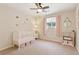 Bedroom with neutral walls, a white crib with pink accents and heart decals on the walls at 3978 Devonshire Dr, Marietta, GA 30066