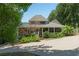 Charming exterior with screened porch, mature landscaping, and concrete driveway at 3978 Devonshire Dr, Marietta, GA 30066