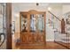 Foyer with hardwood floors, stairs and a beautiful wood china cabinet at 3978 Devonshire Dr, Marietta, GA 30066