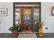 Beautiful stained glass front door flanked by sidelights and planters for added curb appeal at 3978 Devonshire Dr, Marietta, GA 30066