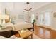 Serene bedroom featuring a ceiling fan, hardwood floors, and access to an outdoor patio at 3978 Devonshire Dr, Marietta, GA 30066