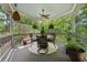 Screened patio with seating, ceiling fan, and views of the beautiful wooded backyard at 3978 Devonshire Dr, Marietta, GA 30066