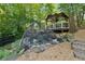 Backyard pond with rock surround, protective net and gazebo feature at 3978 Devonshire Dr, Marietta, GA 30066