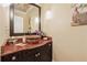 Elegant powder room featuring a vessel sink, granite countertop, and stylish lighting at 3978 Devonshire Dr, Marietta, GA 30066
