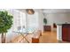Bright dining area with a glass table, modern chandelier, and view of the living room at 200 Renaissance Ne Pkwy # 219, Atlanta, GA 30308