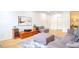 Open-concept living room with hardwood floors, and ample seating at 200 Renaissance Ne Pkwy # 219, Atlanta, GA 30308