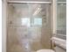 Tiled walk-in shower featuring glass doors, dual shower heads and a granite counter at 200 Renaissance Ne Pkwy # 219, Atlanta, GA 30308