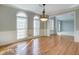 Hardwood floor formal living room with chandelier and white trim at 222 Chadmore Ln, Tyrone, GA 30290