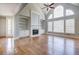 Living room featuring hardwood floors, fireplace, built-ins, and natural light at 222 Chadmore Ln, Tyrone, GA 30290