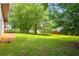 Spacious backyard with mature trees providing shade at 2431 Rosedale Creek Dr, Snellville, GA 30078
