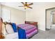 Bedroom features neutral walls, ceiling fan, and carpeted flooring at 2431 Rosedale Creek Dr, Snellville, GA 30078