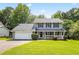 Charming two-story house with a well-manicured lawn and a welcoming front porch with white railings at 2431 Rosedale Creek Dr, Snellville, GA 30078