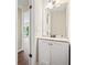 Compact half bath with a stylish vanity featuring a granite countertop and modern fixtures, providing convenience at 2431 Rosedale Creek Dr, Snellville, GA 30078