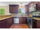 Functional kitchen featuring stainless steel appliances, dark cabinets, and ample counter space for meal preparation at 2431 Rosedale Creek Dr, Snellville, GA 30078
