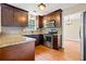 Charming kitchen featuring dark wood cabinets, stainless steel appliances, and ample counter space for cooking at 2431 Rosedale Creek Dr, Snellville, GA 30078