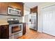 Well-equipped kitchen with stainless steel appliances, dark wood cabinets, and wood floors, designed for functionality at 2431 Rosedale Creek Dr, Snellville, GA 30078