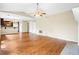 Spacious living area with wood floors, a vaulted ceiling, and an open floor plan to the kitchen, for modern living at 2431 Rosedale Creek Dr, Snellville, GA 30078