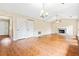 Spacious living room features hardwood flooring, a fireplace and multiple doors at 2431 Rosedale Creek Dr, Snellville, GA 30078