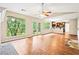Bright living room featuring hardwood floors, large windows and a ceiling fan at 2431 Rosedale Creek Dr, Snellville, GA 30078