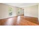 Bright living room featuring wood floors, two windows, and neutral paint, creating a welcoming atmosphere at 2431 Rosedale Creek Dr, Snellville, GA 30078