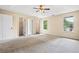 Spacious main bedroom features a ceiling fan, neutral carpet, and two walk-in closets at 2431 Rosedale Creek Dr, Snellville, GA 30078