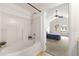 Bright bathroom with tub/shower combo and partial view into the bedroom at 2964 Greyhawk Ln # 160, Cumming, GA 30040