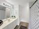 Well-lit bathroom with shower/tub combination, white vanity, and large mirror at 2964 Greyhawk Ln # 160, Cumming, GA 30040