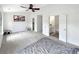 Spacious primary bedroom with a ceiling fan, carpet floor and multiple doorways at 2964 Greyhawk Ln # 160, Cumming, GA 30040