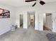 Spacious primary bedroom with a ceiling fan, carpet floor and multiple doorways at 2964 Greyhawk Ln # 160, Cumming, GA 30040