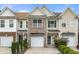 Charming townhome with brick accents, an attached garage, and manicured landscaping at 2964 Greyhawk Ln # 160, Cumming, GA 30040